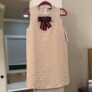 Elegant Cream Sleeveless Dress with Bow Accent